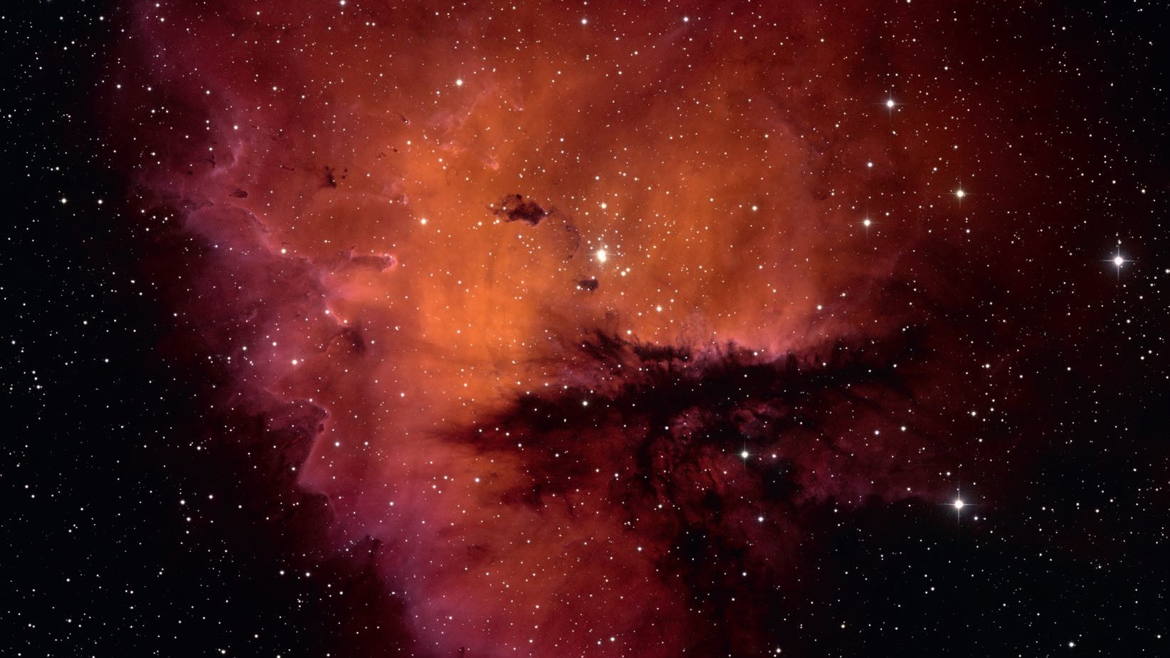 Formen på NGC 281 påminner både fotografiskt och visuellt om Pacman-figuren. NSF/AURA/WIYN/T. Rektor (Alaskas universitet)